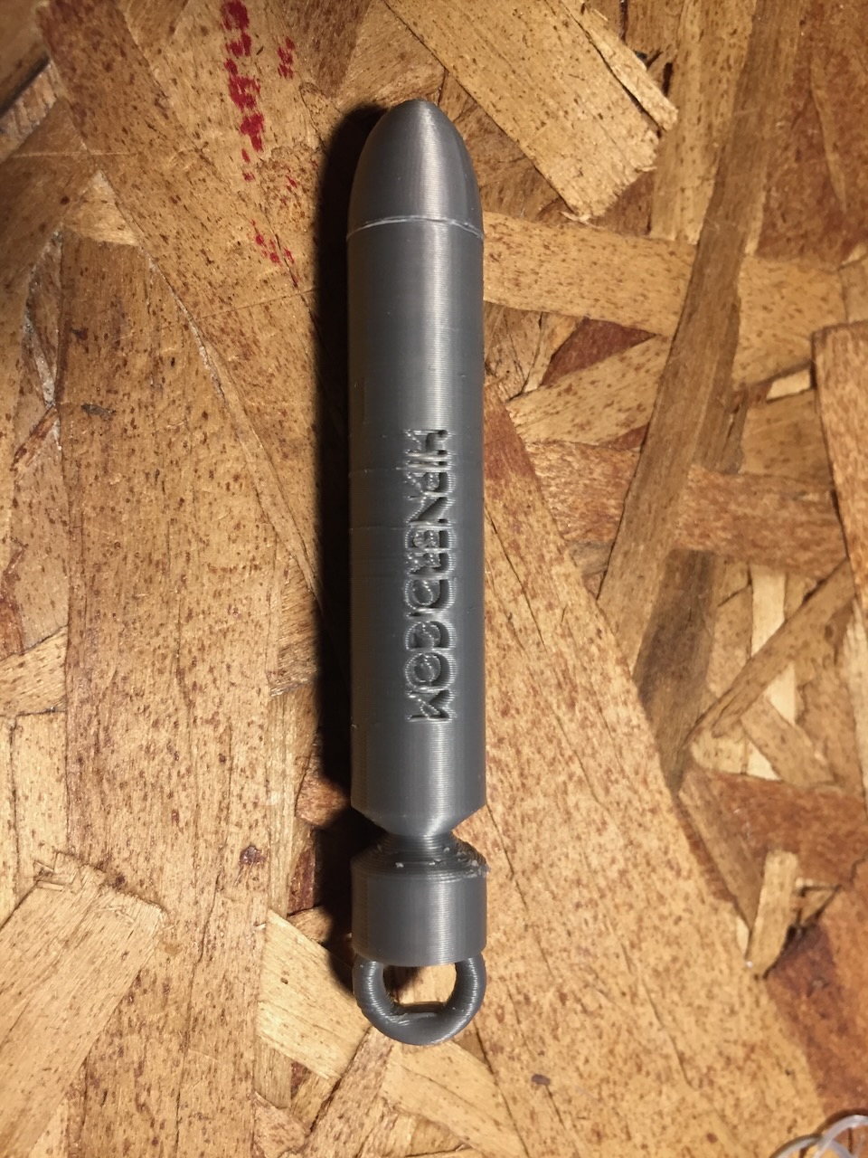 An invention to fix drawstrings that come out of clothing (like sweatpants or hoodies), it's bullet shaped with a ring at one end to fasten the drawstring to.